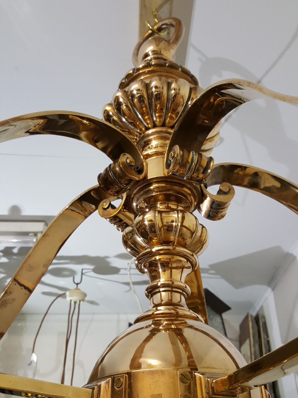A Victorian style polished bronze and brass ceiling light fixture featuring a central ring frame with scrolled upper supports and frosted cut glass shades. View VII