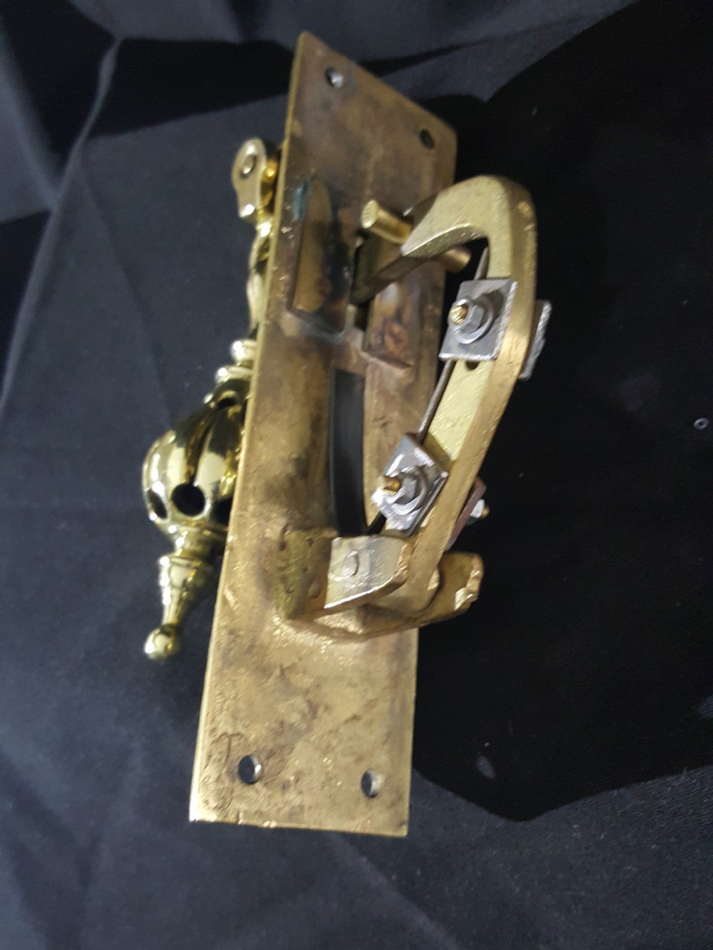 A polished brass Georgian style pull bell mechanism featuring an openwork teardrop handle and rectangular backplate with mounting holes. View III