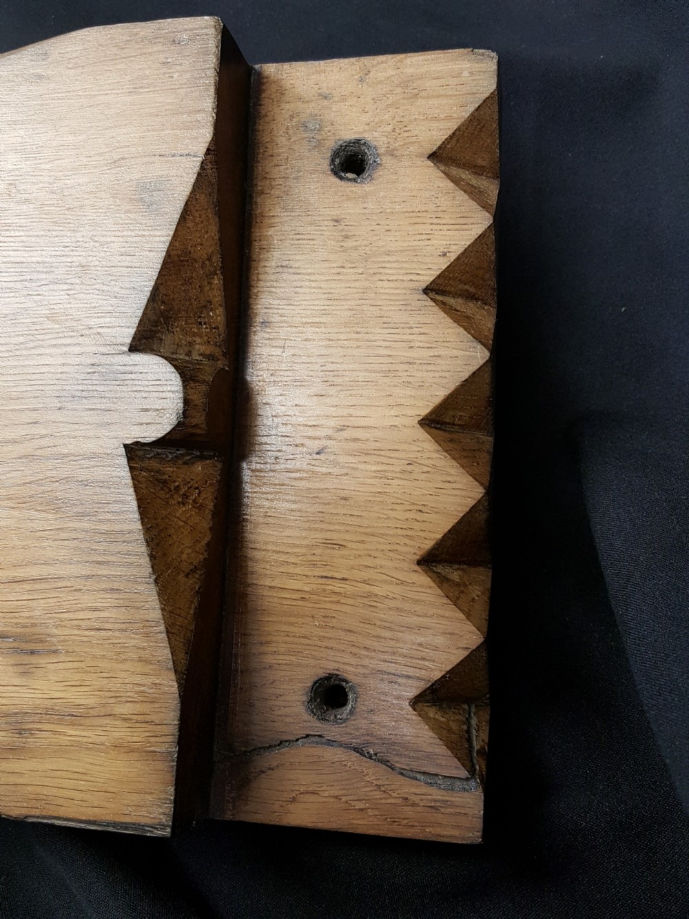 A rectangular Georgian oak wooden stock lock featuring an open keyhole and an accompanying wrought iron key resting on the timber surface. View IV