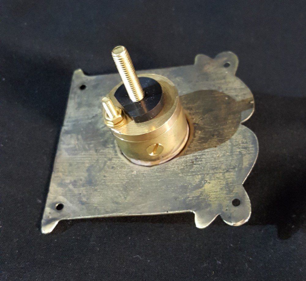 A square polished brass Art Nouveau bell push featuring stylised botanical relief motifs and a central white porcelain button with the word PUSH printed in black. View IV