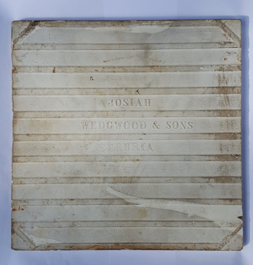 A square Victorian ceramic tile featuring a sepia transfer print of a female figure harvesting fruit under a tree with September written below, surrounded by a foliage border. View III
