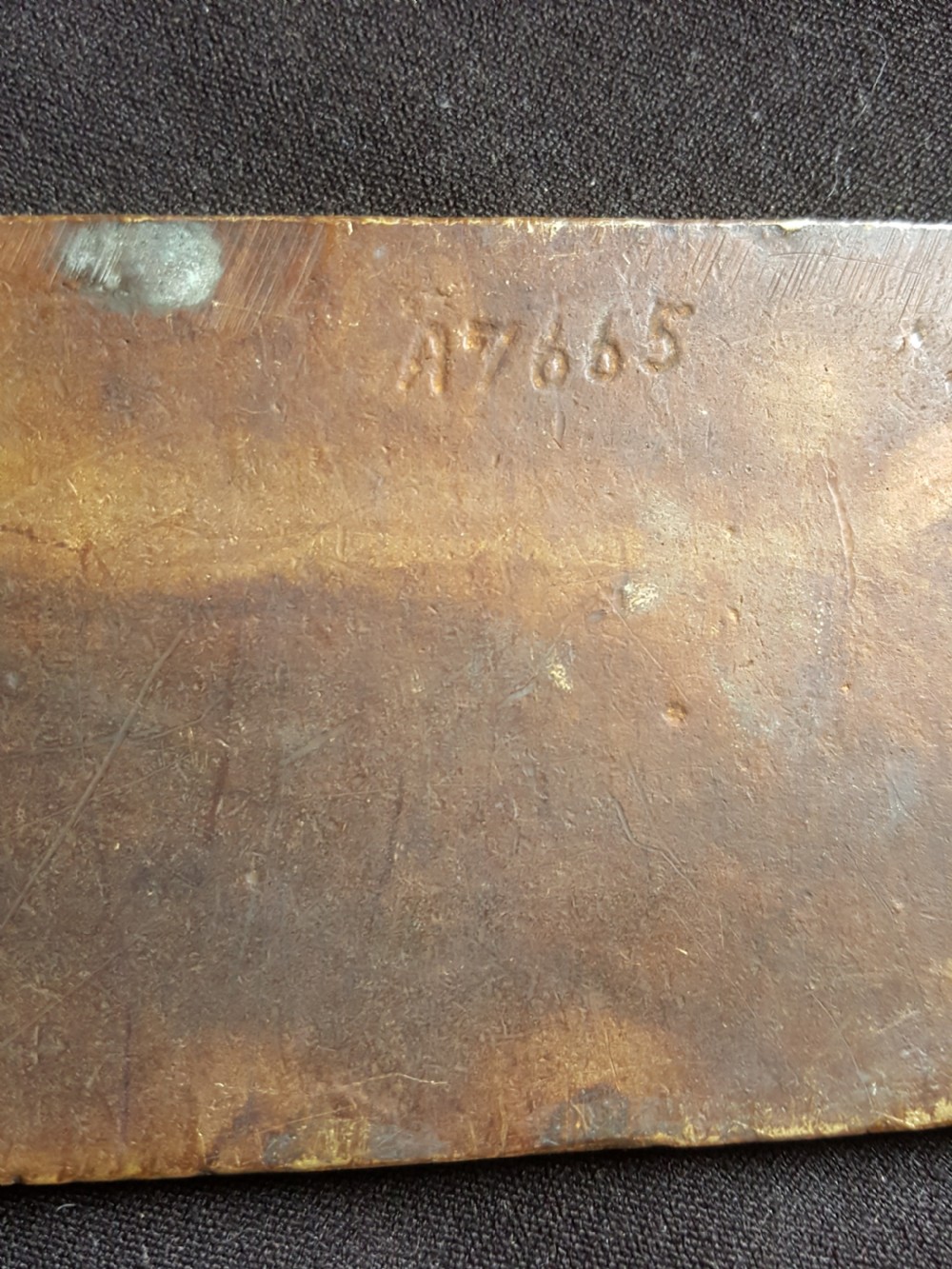 A single cast brass Georgian style finger plate displaying scrollwork and cartouche relief detailing at top and bottom ends. View V