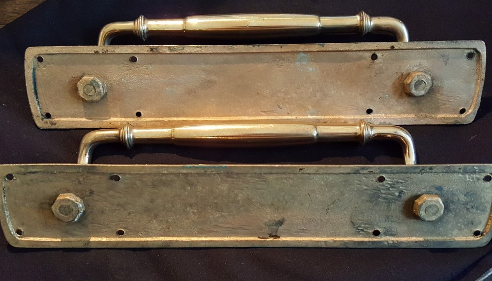 A pair of polished brass Victorian door pull handles mounted on long rectangular backplates with pre-drilled fixing holes. View III