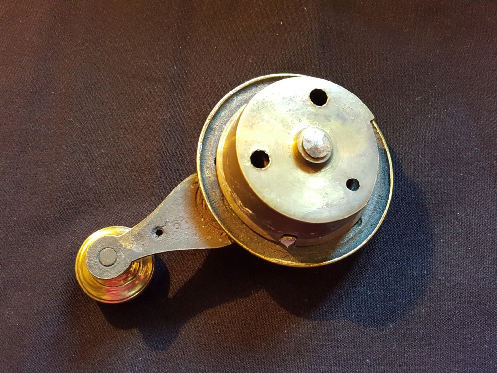An ornate Victorian brass bell ringer featuring elaborate embossed floral patterns and a mechanical turn lever. View IV