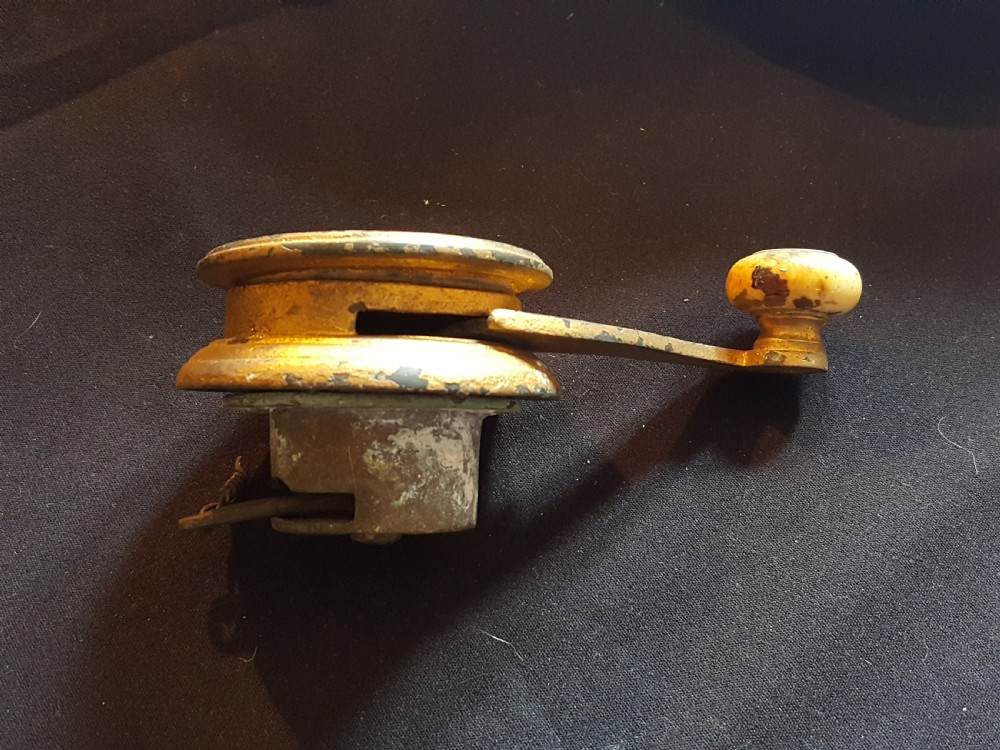 An ornate Georgian cast brass servant bell lever featuring a carved leaf rosette backplate and a turned horn handle. View III
