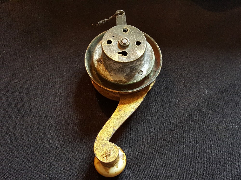 An ornate Georgian cast brass servant bell lever featuring a carved leaf rosette backplate and a turned horn handle. View IV