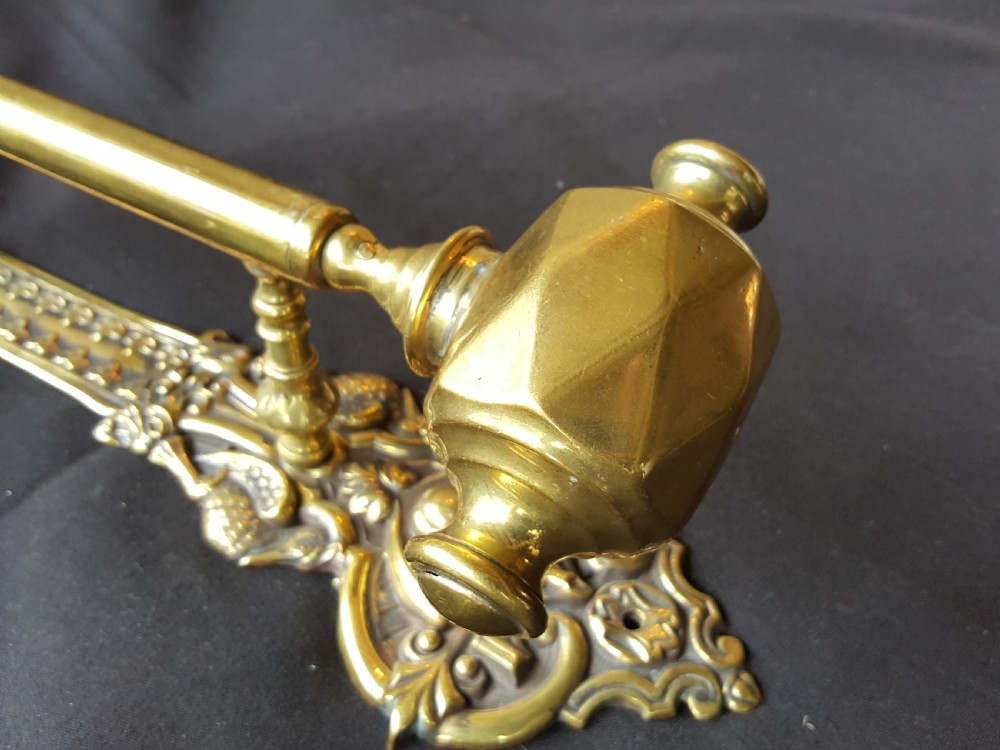 An ornate Victorian solid brass mechanical door bell pull featuring a faceted knob, rod lever mechanism, and cast foliate backplate. View II