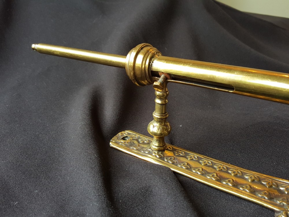 An ornate Victorian solid brass mechanical door bell pull featuring a faceted knob, rod lever mechanism, and cast foliate backplate. View V