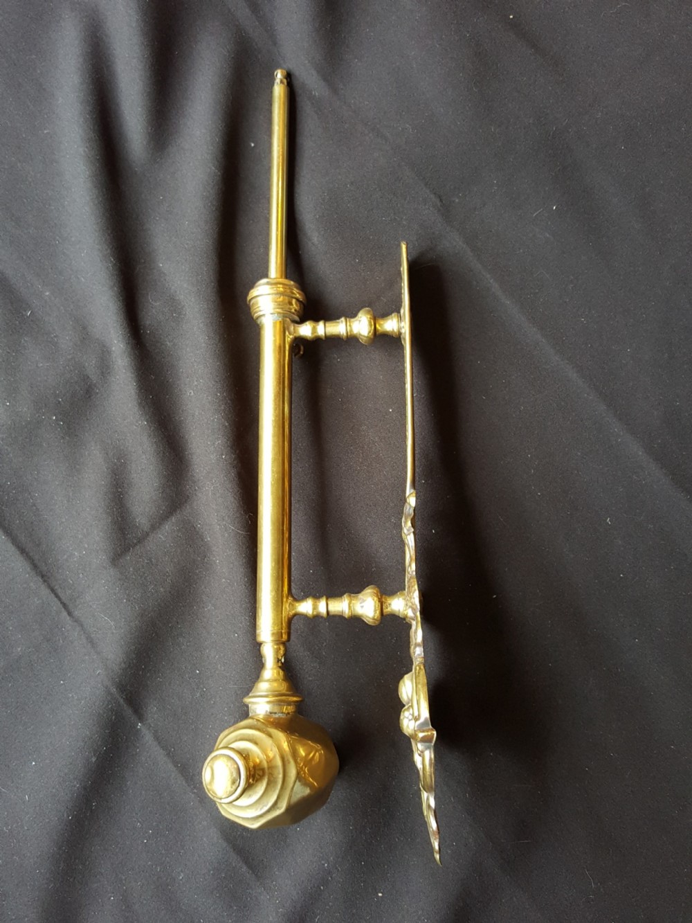 An ornate Victorian solid brass mechanical door bell pull featuring a faceted knob, rod lever mechanism, and cast foliate backplate. View VI