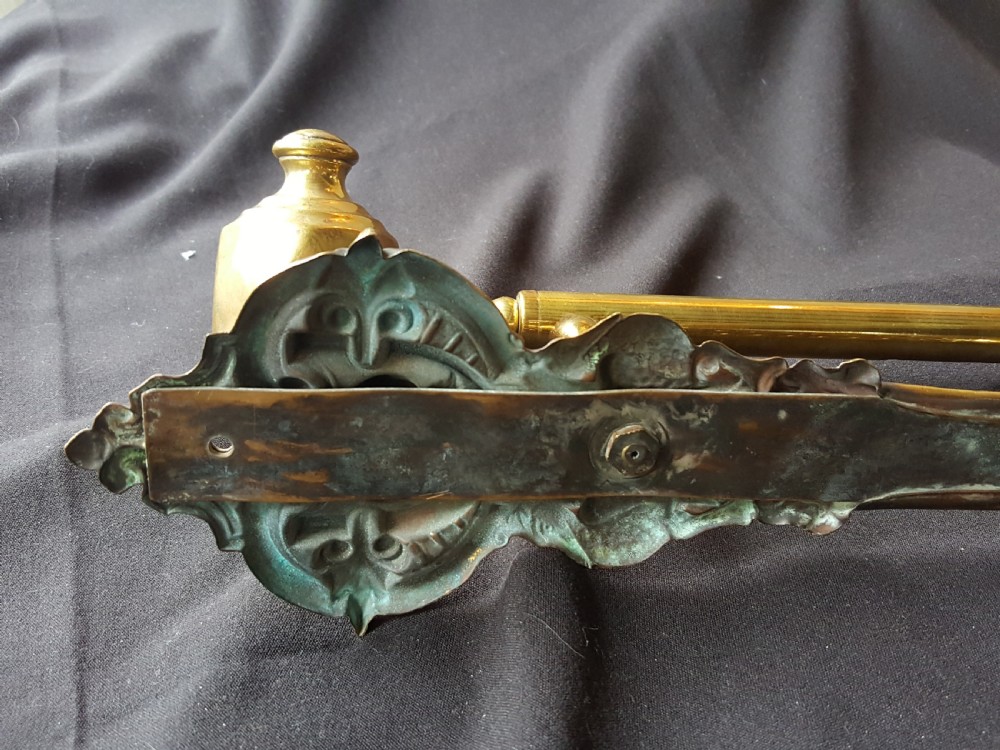 An ornate Victorian solid brass mechanical door bell pull featuring a faceted knob, rod lever mechanism, and cast foliate backplate. View VIII