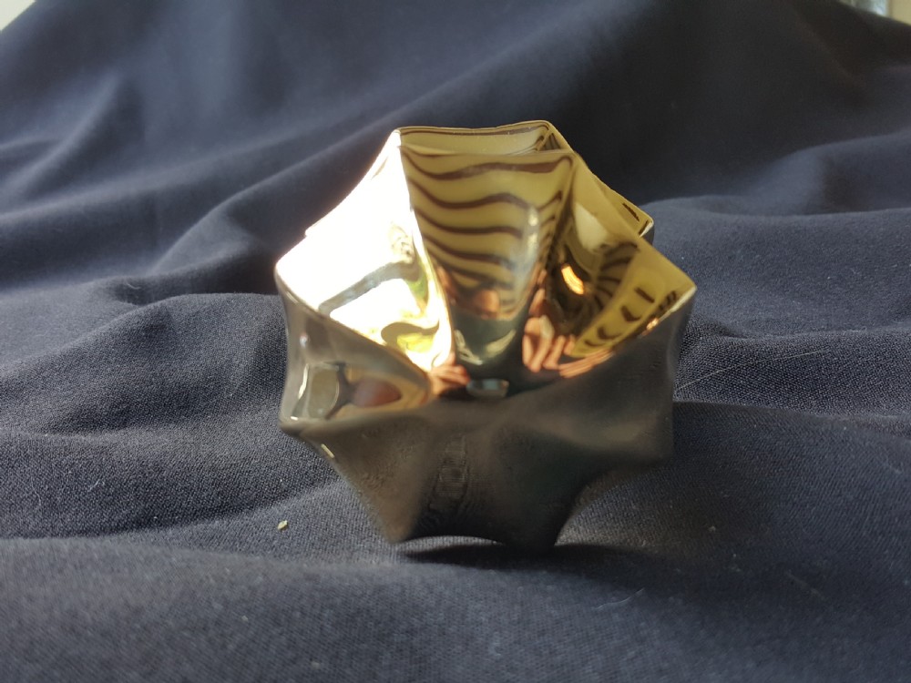 A polished brass centre door knob featuring a multi-fluted star shape with an attached threaded mounting bolt. View VI
