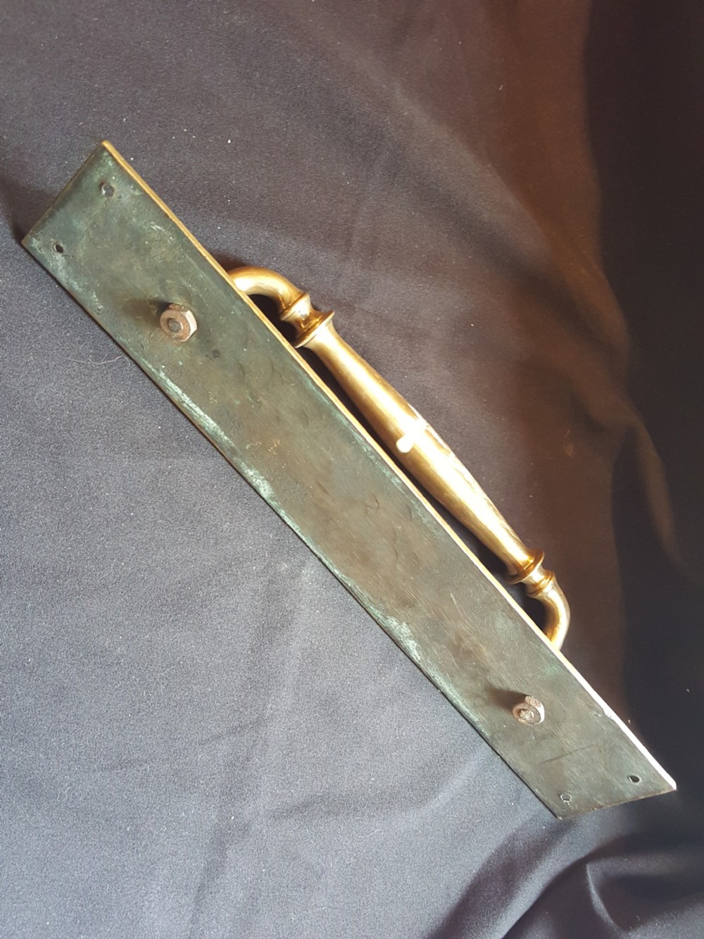 A solid brass Edwardian door pull handle mounted on a rectangular backplate with four corner mounting holes. View III