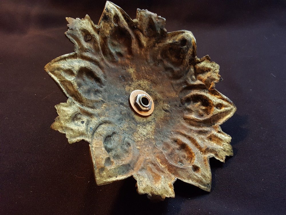 An ornate circular Victorian cast brass ceiling rose featuring relief foliage decoration and a central hanging hook. View VI