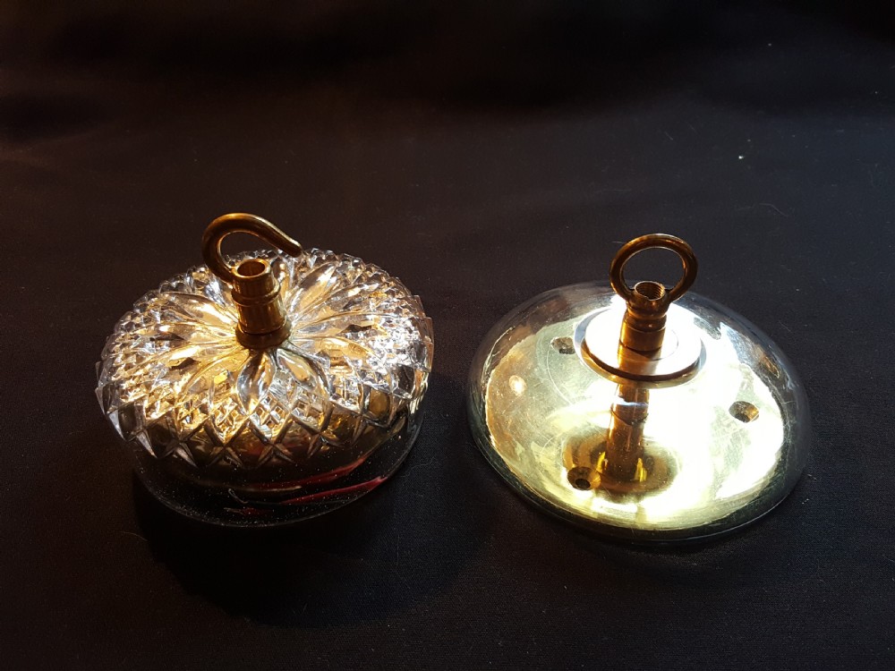A pair of Victorian clear glass ceiling roses featuring central brass mounting hooks and diamond cut glass detailing.