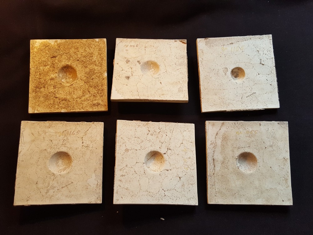 A set of six Victorian square earthenware tiles featuring high-relief moulded scrollwork and central cabochons in ochre and brown glazes. View VII