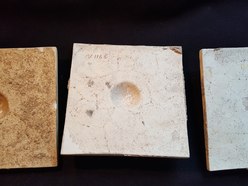 A set of six Victorian square earthenware tiles featuring high-relief moulded scrollwork and central cabochons in ochre and brown glazes. View IX