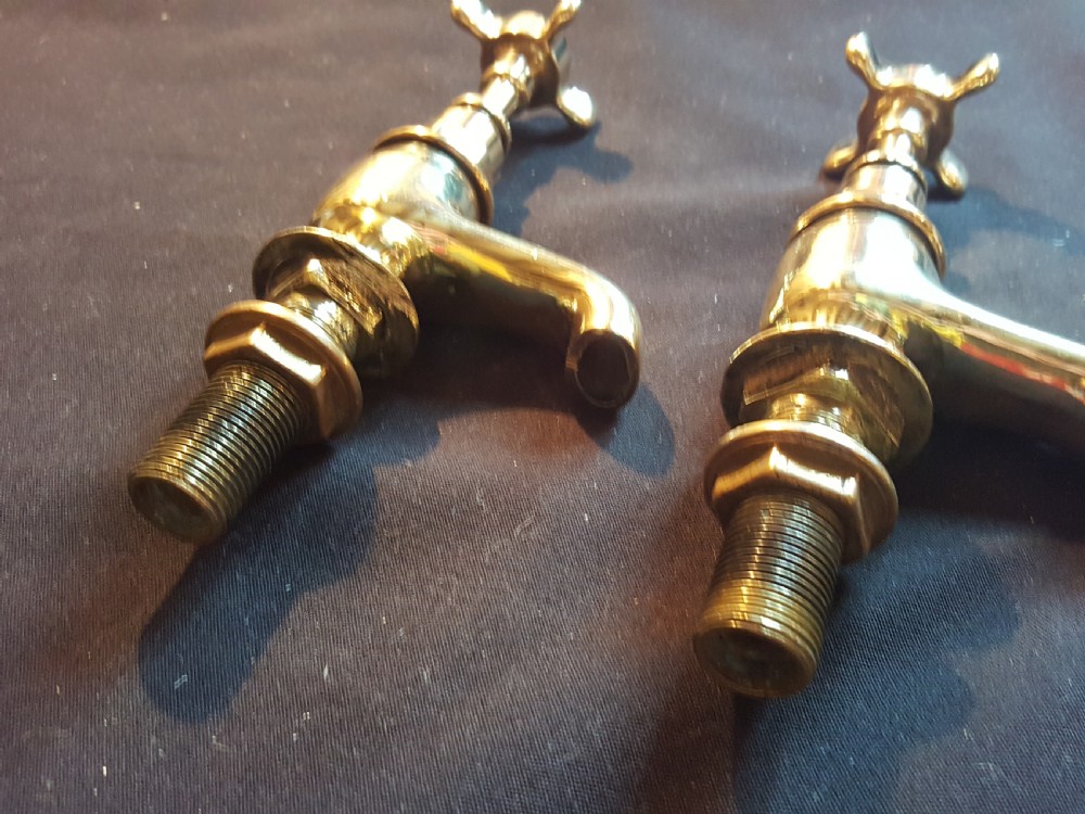 A pair of restored Victorian polished brass bath taps featuring crosshead handles and threaded mounting pillars. View II