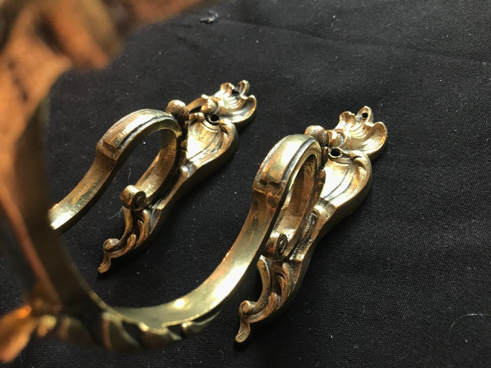 A pair of heavy cast brass curtain tiebacks featuring sculpted acanthus leaf and C-scroll motifs. View II