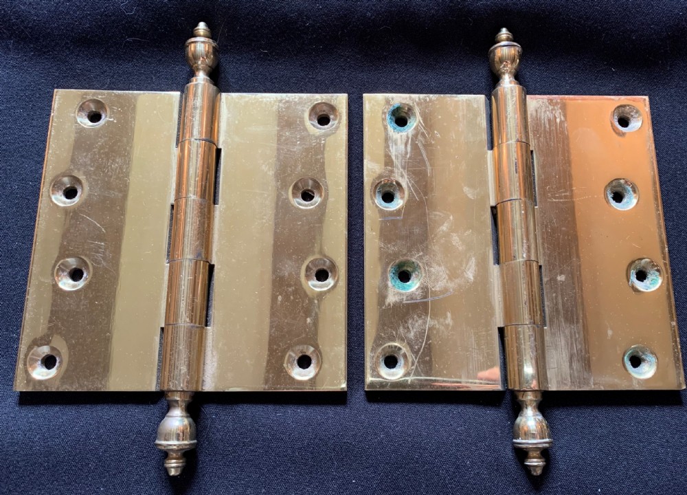 A pair of solid brass Victorian door hinges featuring decorative turned finials at both ends of each hinge pin. View III