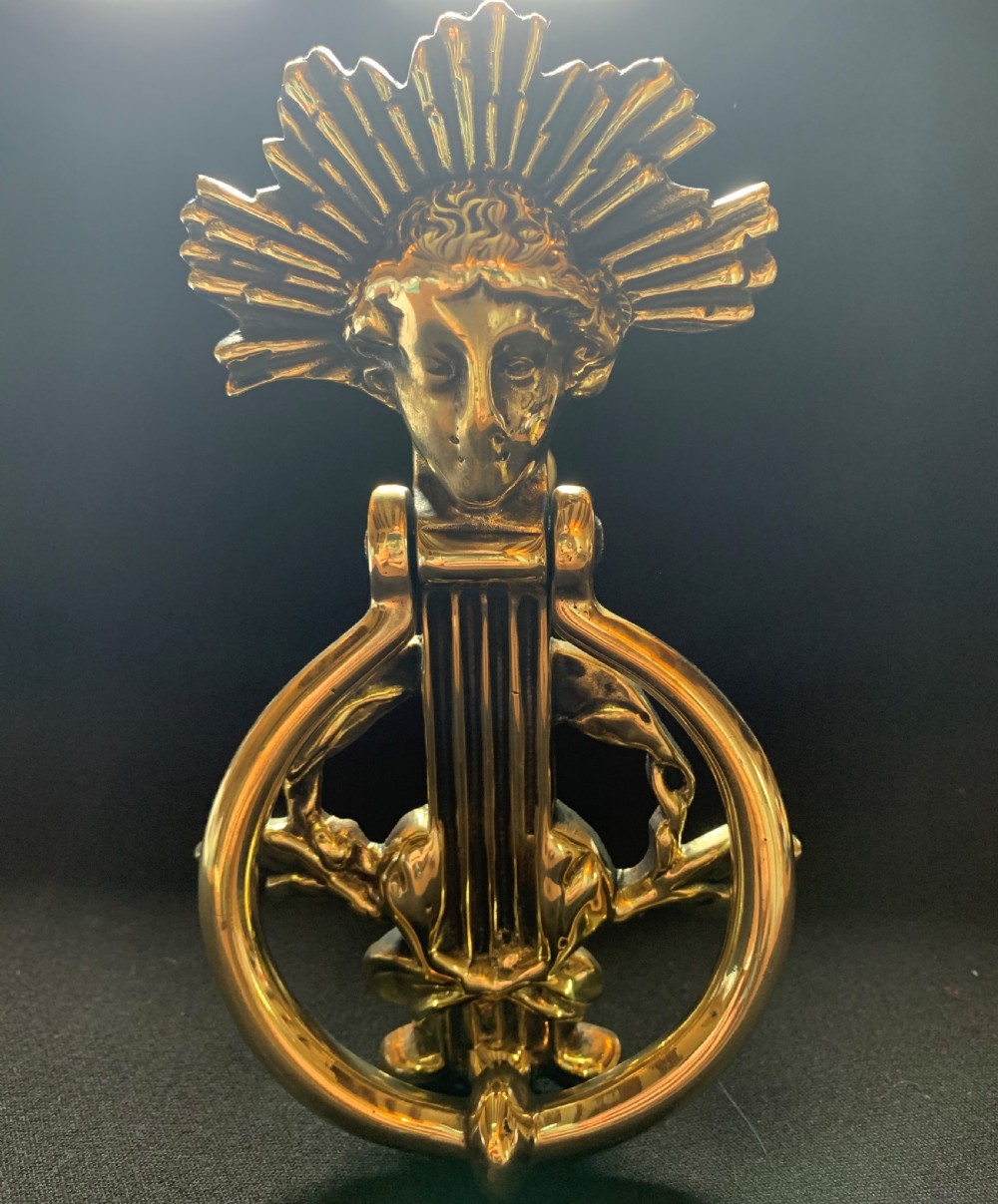 One Brass French Cherub's Face Door Knocker.