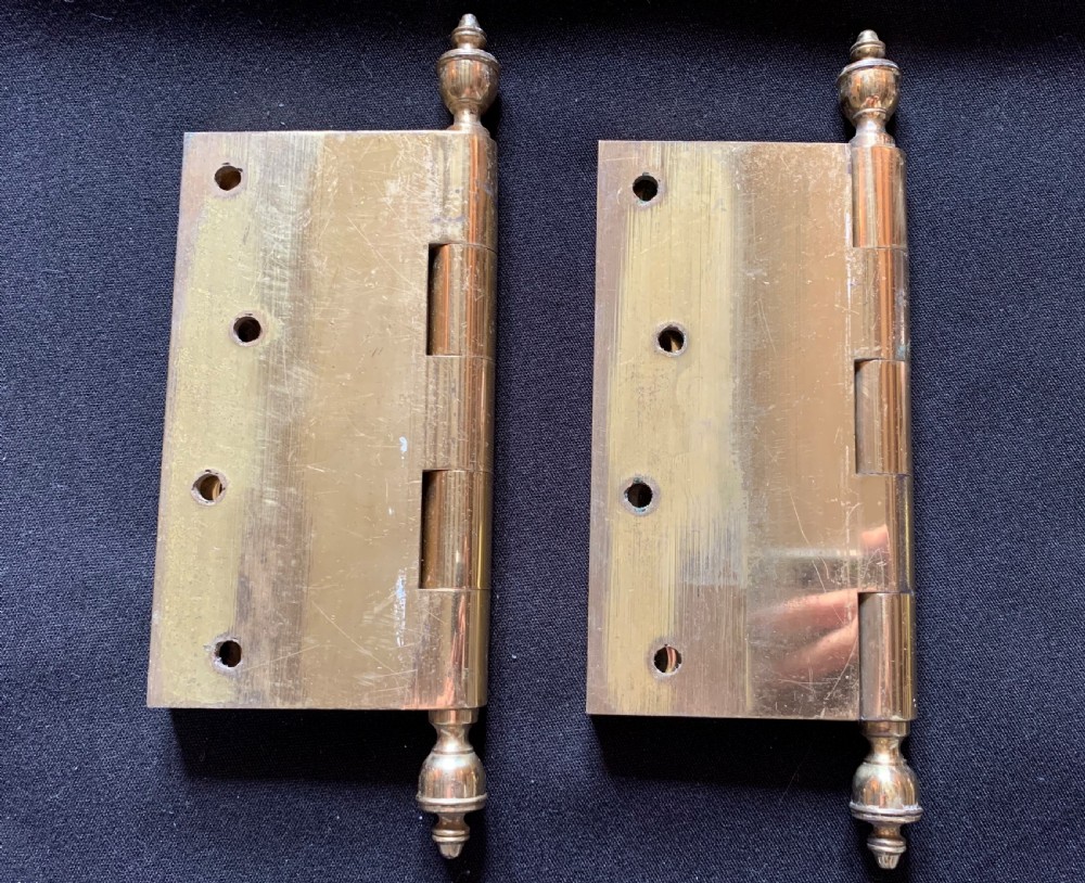 A pair of solid brass Victorian butt door hinges featuring turned urn finials at the top and bottom of each hinge pin. View II