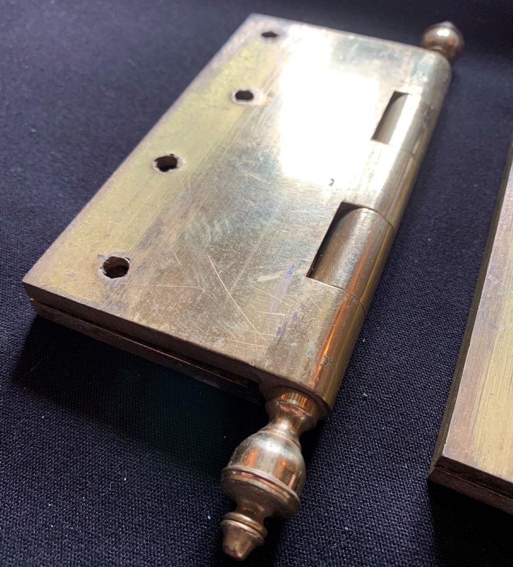 A pair of solid brass Victorian butt door hinges featuring turned urn finials at the top and bottom of each hinge pin. View IV