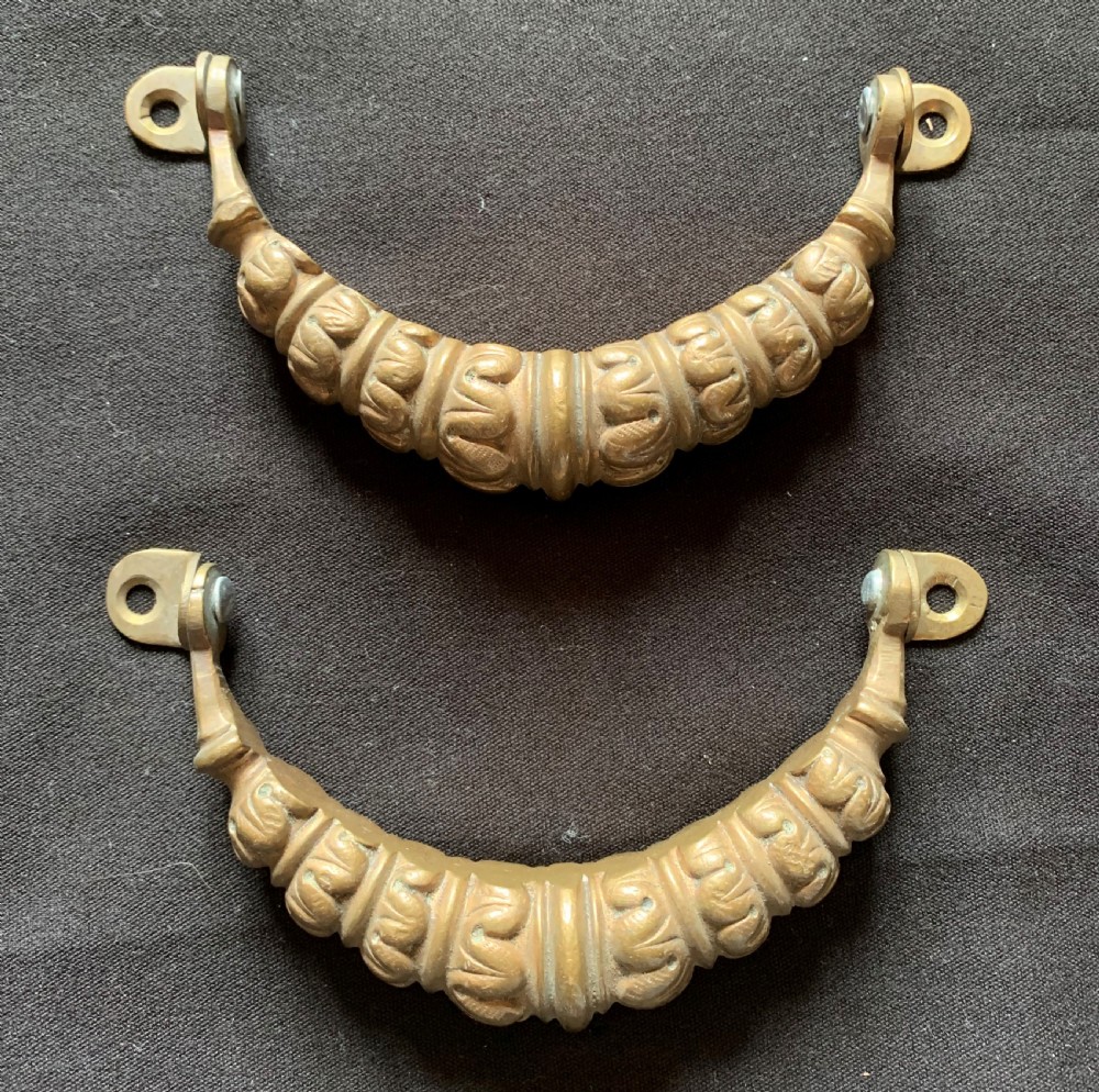 A pair of carved Victorian bronze drop handles featuring leaf detail and integrated swivel mounting loops.