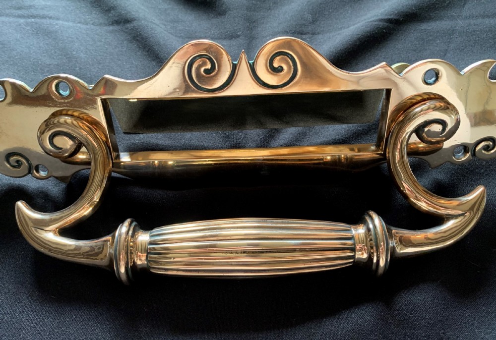 A polished Victorian bronze letter plate featuring an integrated scroll door pull handle and engraved scrollwork details. View III