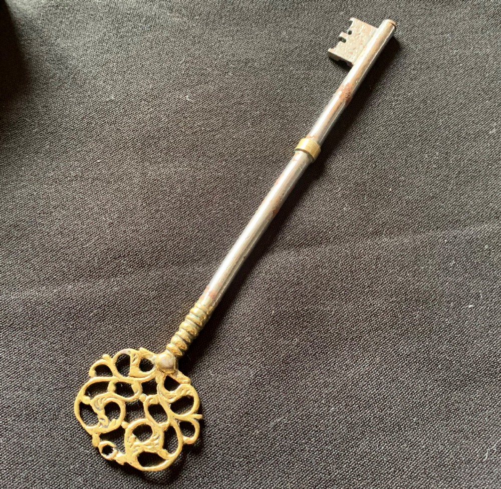 A rectangular French Victorian brass and polished steel rim lock with a beaded edge frame and an ornate matching key. View IV