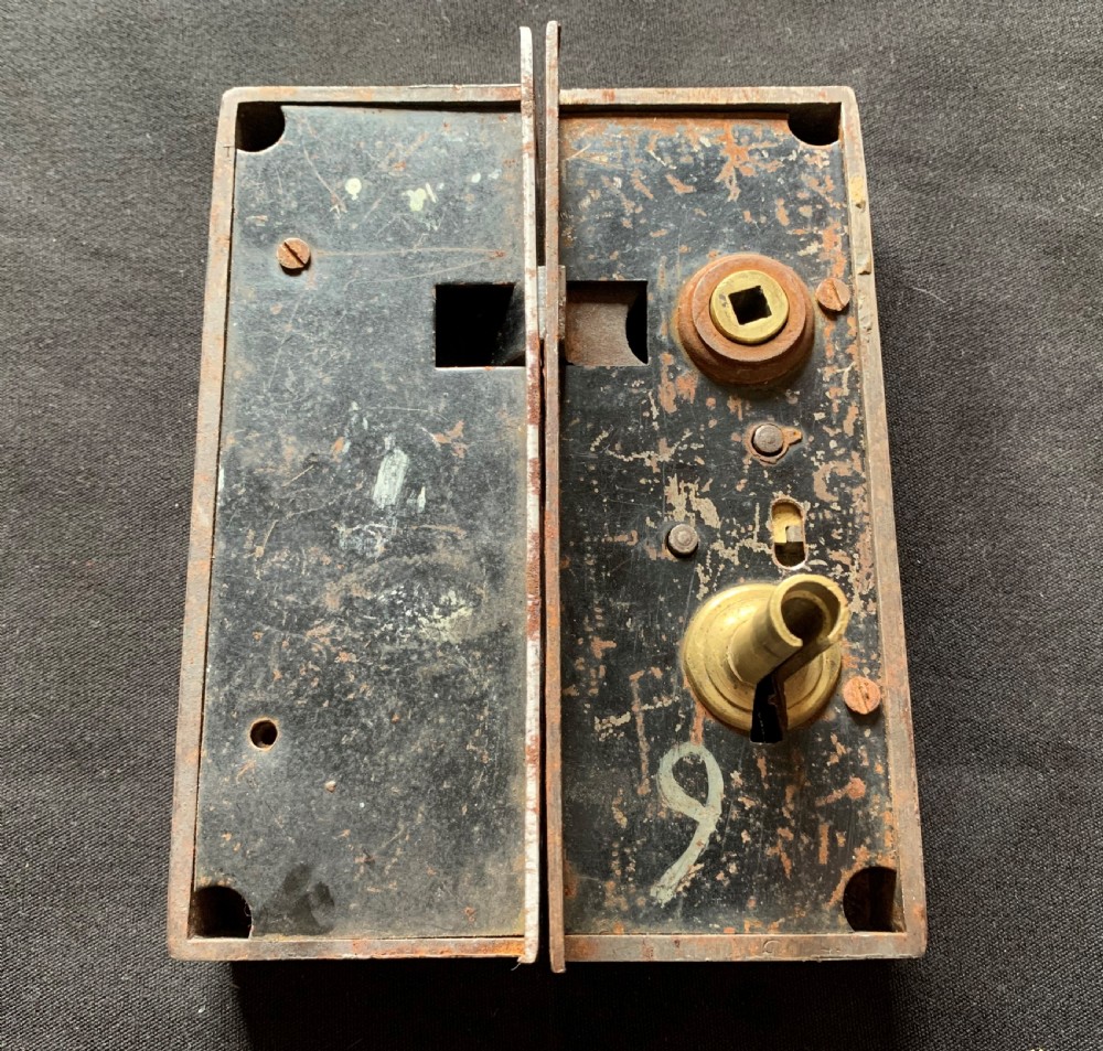 A rectangular French Victorian brass and polished steel rim lock with a beaded edge frame and an ornate matching key. View V