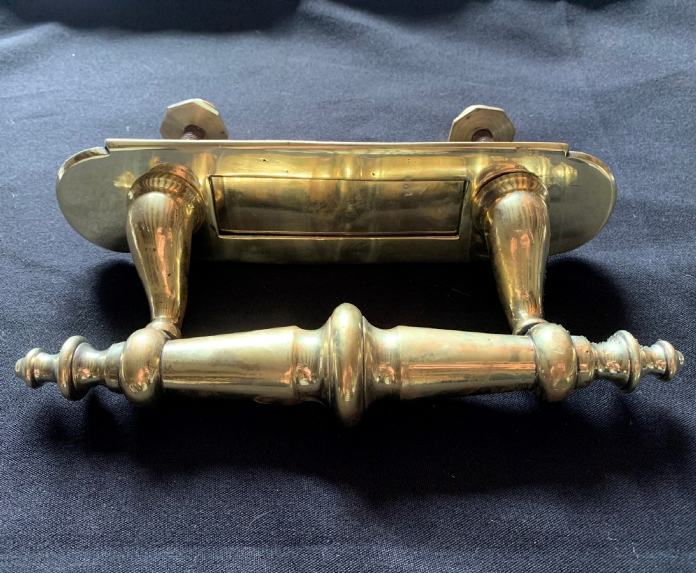 A polished brass Victorian letter box plate combined with an integrated turned door pull handle and rear fixing bolts.