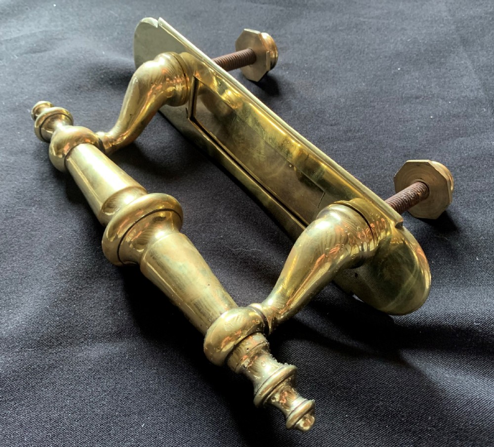 A polished brass Victorian letter box plate combined with an integrated turned door pull handle and rear fixing bolts. View IV