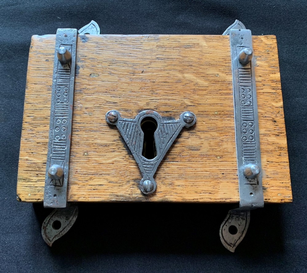 An antique Victorian surface-mounted wooden rim lock crafted from oak with decorative steel straps, accompanied by a steel keep and an original iron key. View III