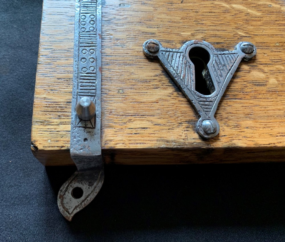 An antique Victorian surface-mounted wooden rim lock crafted from oak with decorative steel straps, accompanied by a steel keep and an original iron key. View IV