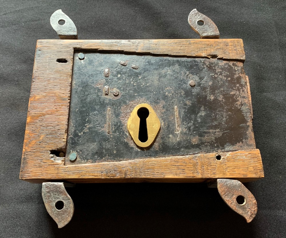 An antique Victorian surface-mounted wooden rim lock crafted from oak with decorative steel straps, accompanied by a steel keep and an original iron key. View V