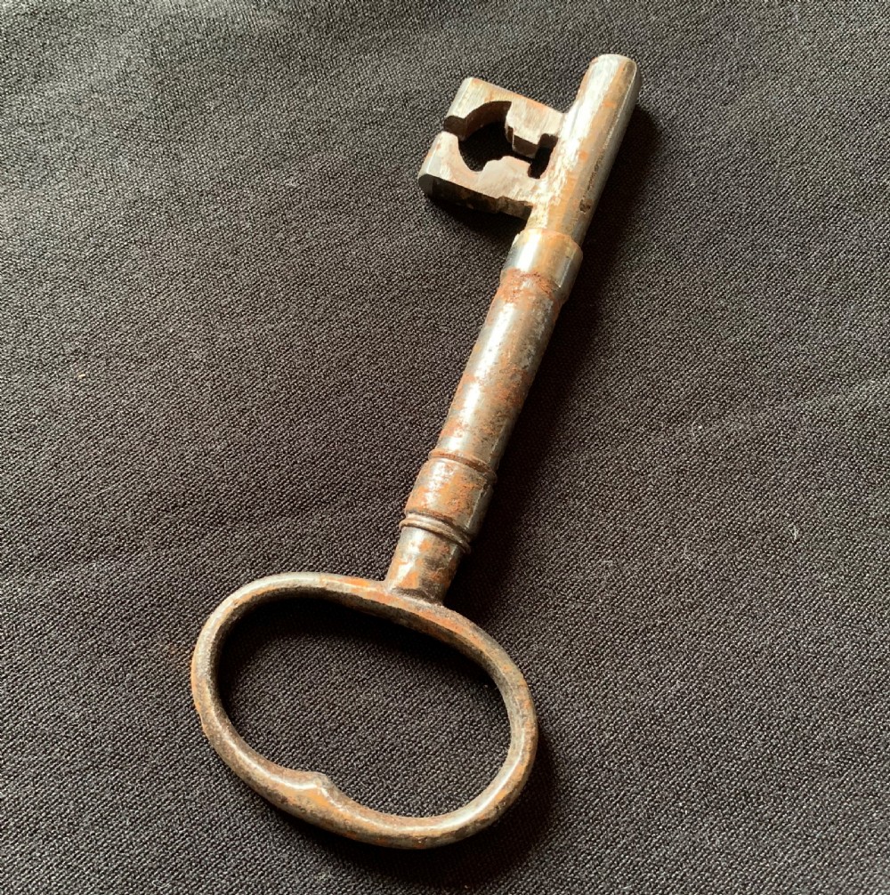 An antique Victorian surface-mounted wooden rim lock crafted from oak with decorative steel straps, accompanied by a steel keep and an original iron key. View VI