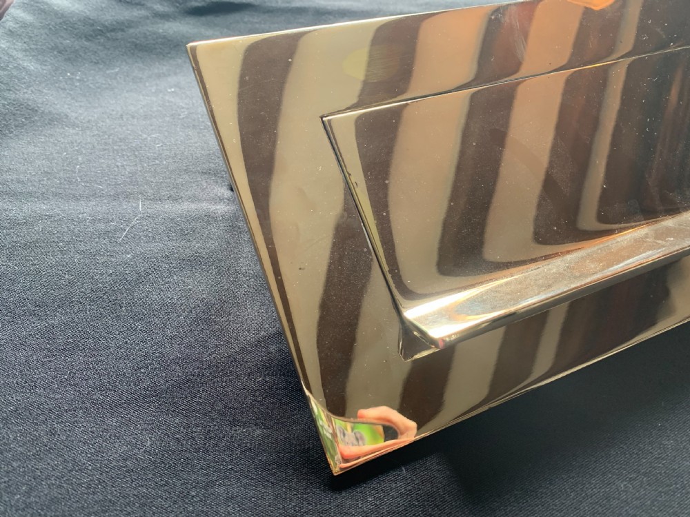 A polished brass rectangular Victorian letter box plate featuring a hinged central flap with an ergonomic lower lip. View II