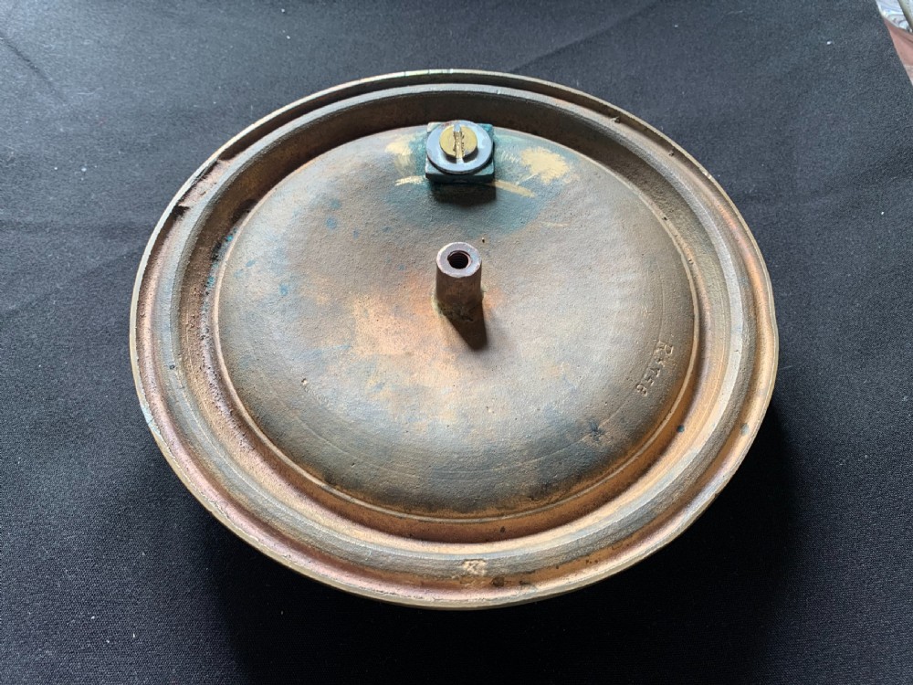 A circular polished brass Georgian door knocker with a heavy ring handle mounted on a moulded circular backplate. View VI