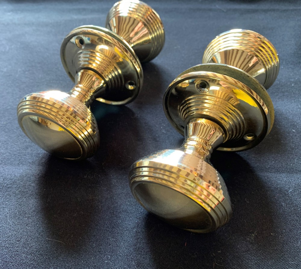 Two pairs of polished brass Victorian beehive door knobs with reeded bodies and circular rose plates. View II