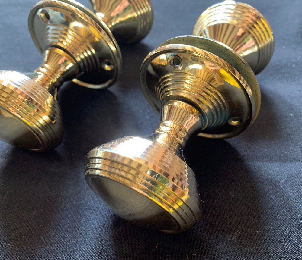 Two pairs of polished brass Victorian beehive door knobs with reeded bodies and circular rose plates. View III