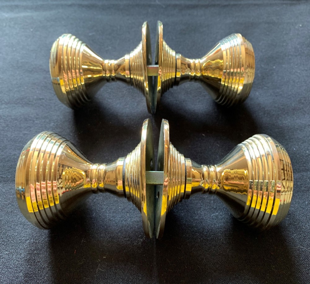 Two pairs of polished brass Victorian beehive door knobs with reeded bodies and circular rose plates. View IV