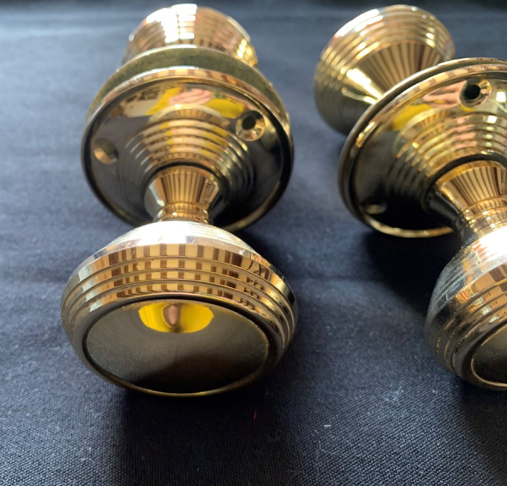 Two pairs of polished brass Victorian beehive door knobs with reeded bodies and circular rose plates. View VI