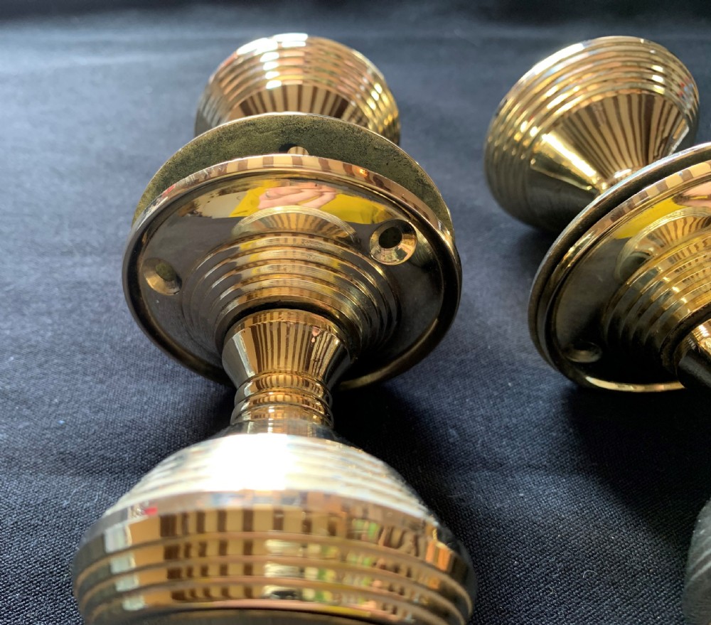 Two pairs of polished brass Victorian beehive door knobs with reeded bodies and circular rose plates. View VII