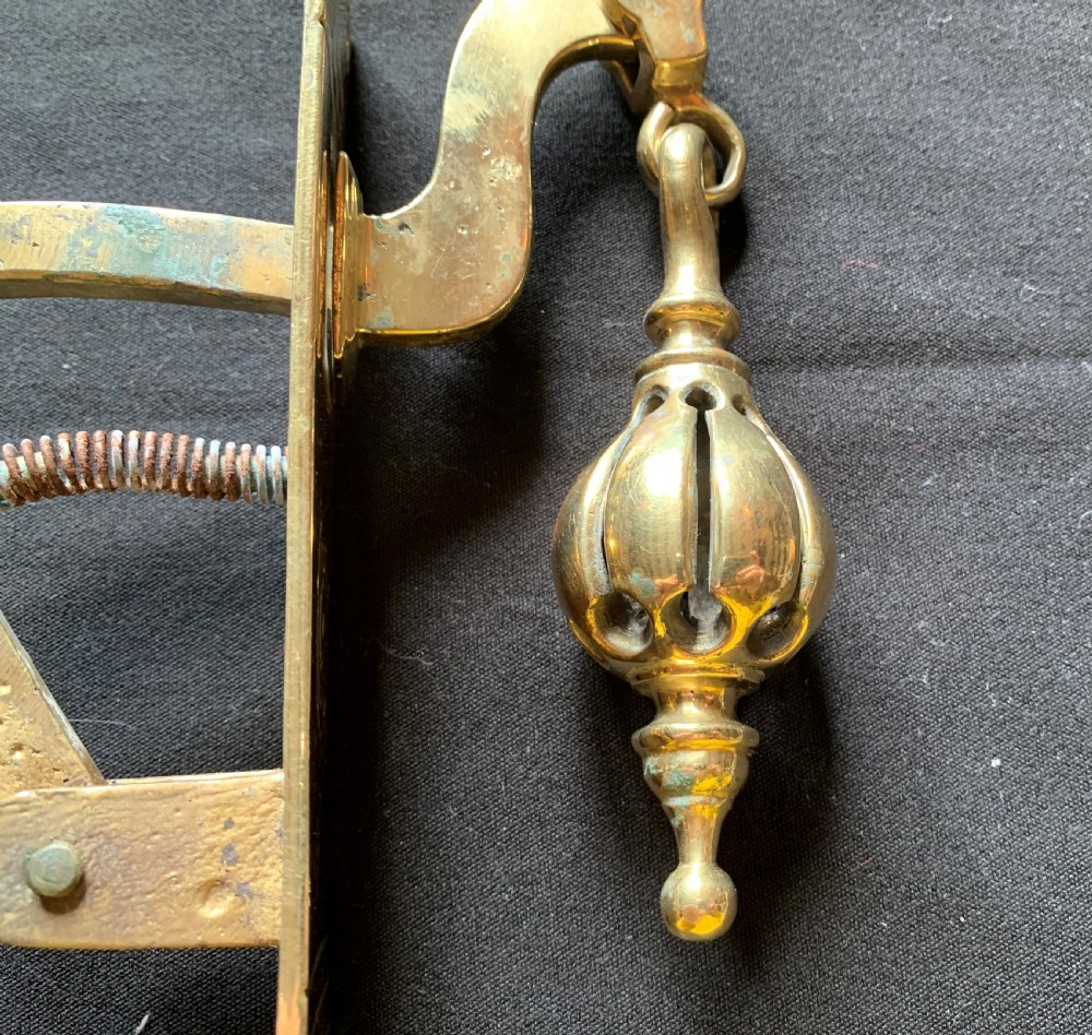 A brass Georgian mechanical doorbell pull featuring a rectangular backplate engraved with concentric circles and a bulbous drop handle. View VIII