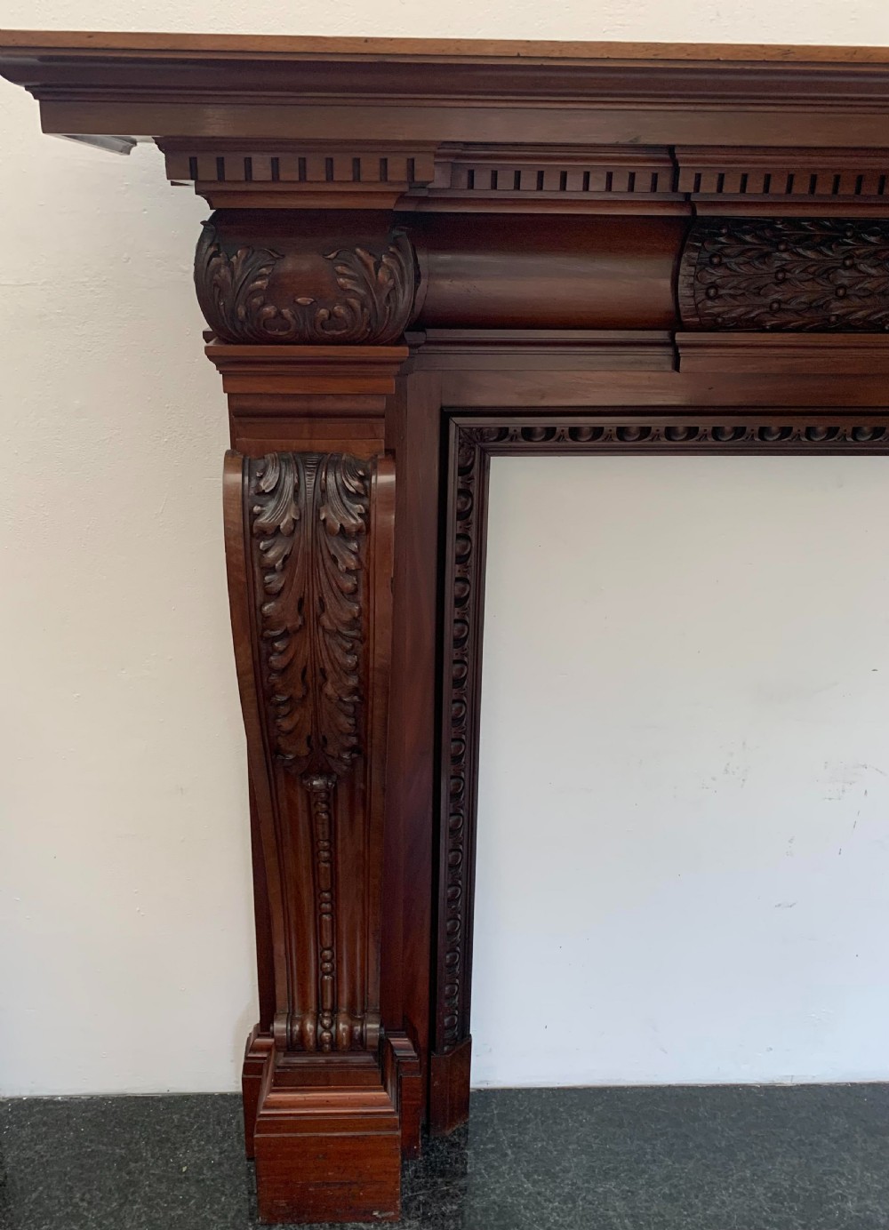 A Victorian carved mahogany fireplace surround featuring prominent acanthus leaf corbels, bead moulding, and a carved central frieze. View II
