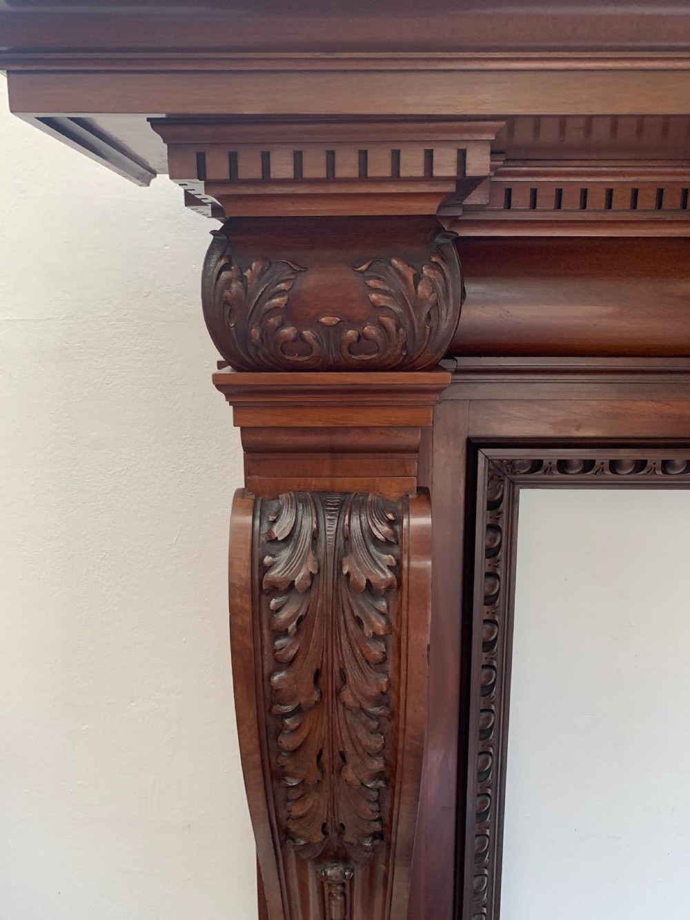 A Victorian carved mahogany fireplace surround featuring prominent acanthus leaf corbels, bead moulding, and a carved central frieze. View III