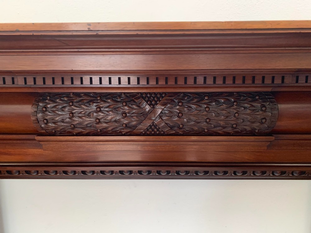 A Victorian carved mahogany fireplace surround featuring prominent acanthus leaf corbels, bead moulding, and a carved central frieze. View IV