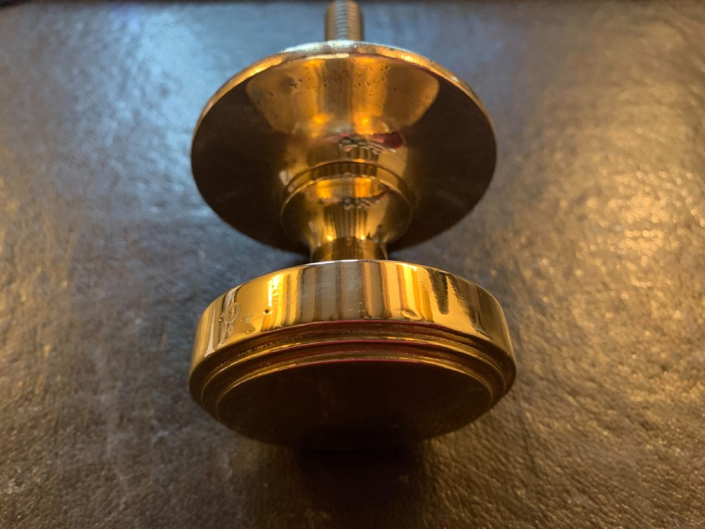 A polished bronze Edwardian centre door knob featuring a circular stepped backplate and a threaded rear fixing bolt. View III
