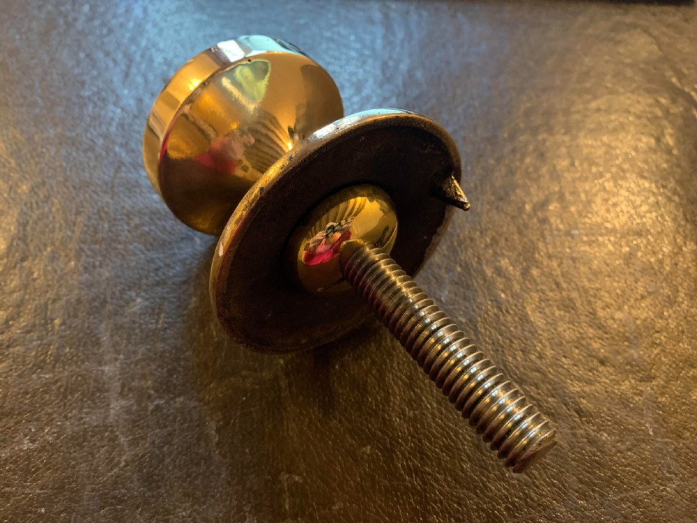 A polished bronze Edwardian centre door knob featuring a circular stepped backplate and a threaded rear fixing bolt. View IV