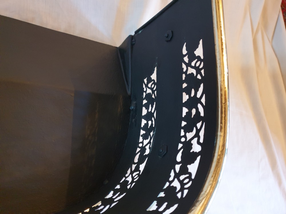 A Victorian brass fireplace fender featuring pierced fretwork patterns, rounded corners, and turned feet. View IV